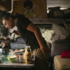 Christian Torres cooks food in the van where he lives in Berkeley.